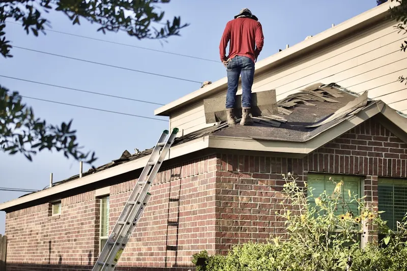 Professional roofer working on a residential roof in Geraghty Village